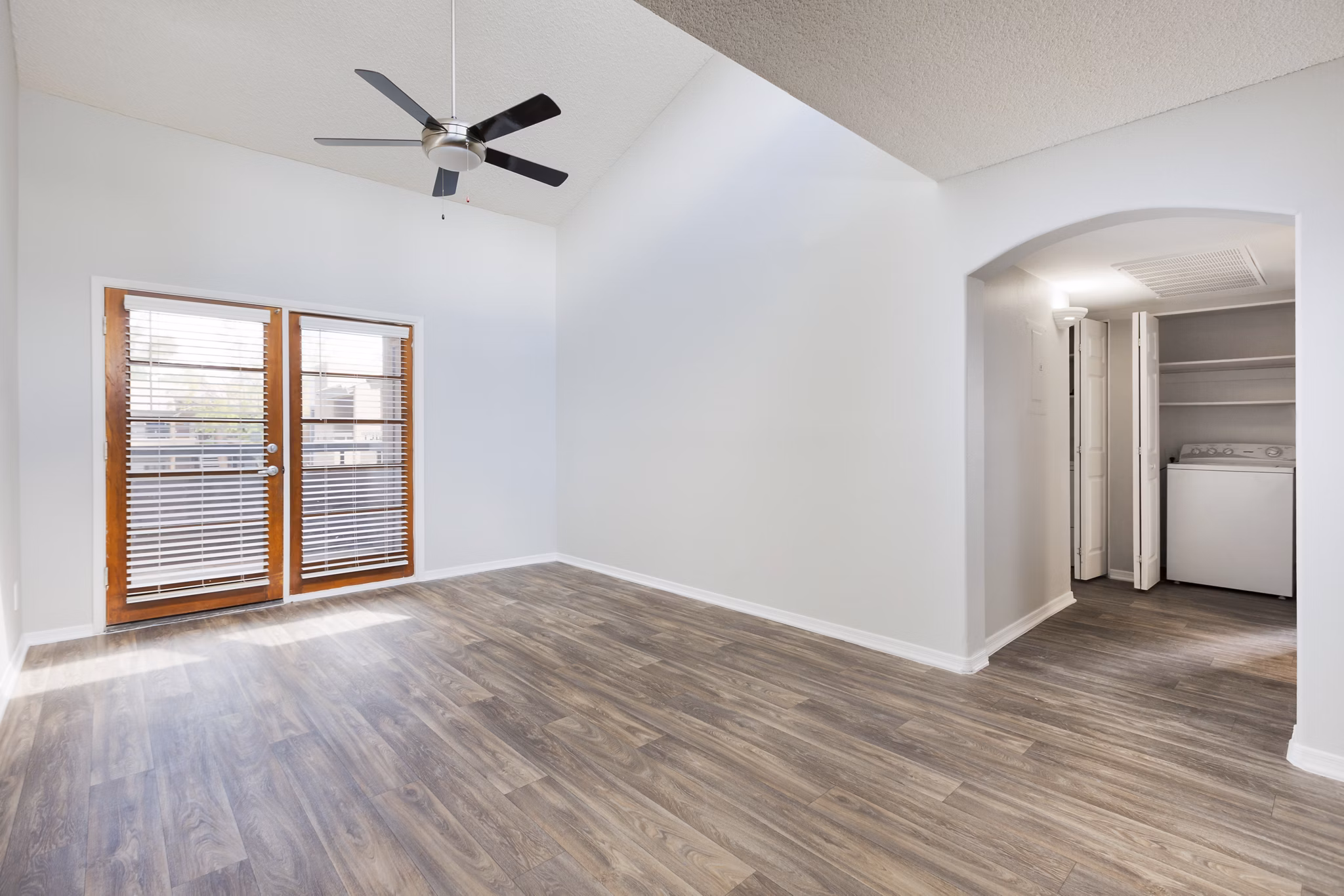 Luxurious living room with modern decor and ample natural light at The Bella Apartments
