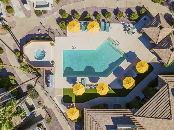 Resort-style pool with lounge area at The Bella Apartments, a Greystar luxury living experience