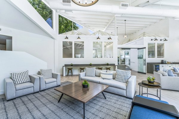 Stylish clubhouse with modern seating and fireplace at Kensington Apartments, a luxury  community