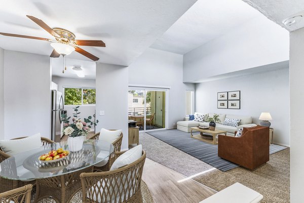 Dining area featuring elegant chandelier and hardwood floors in Kensington Apartments