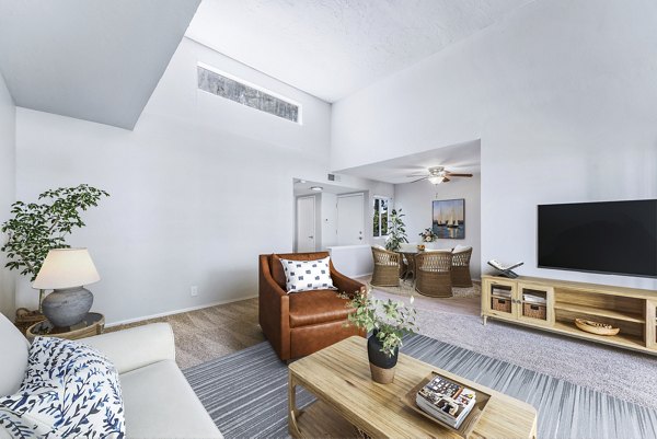 Bright living room with large windows and modern decor at Kensington Apartments