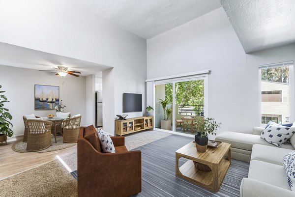 Modern living room featuring contemporary decor and ample natural light at Kensington Apartments