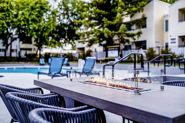 Cozy fire pit and patio area at Kensington Apartments in a luxurious setting, great for outdoor relaxation and gatherings