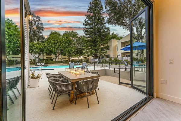 Fire pit on cozy patio at Kensington Apartments, perfect for gatherings and relaxation in a luxury setting