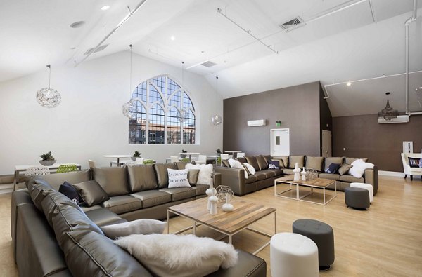 Modern clubhouse with cozy seating and fireplace at Highlands 32 Apartments, offering luxury living in Greystar's premier community