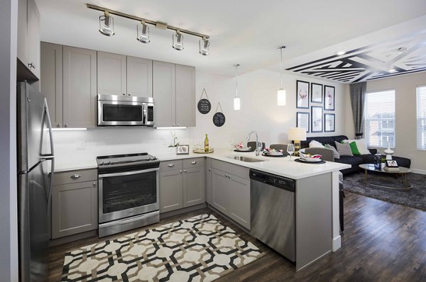 Modern kitchen with stainless steel appliances at Highlands 32 Apartments, a Greystar luxury community
