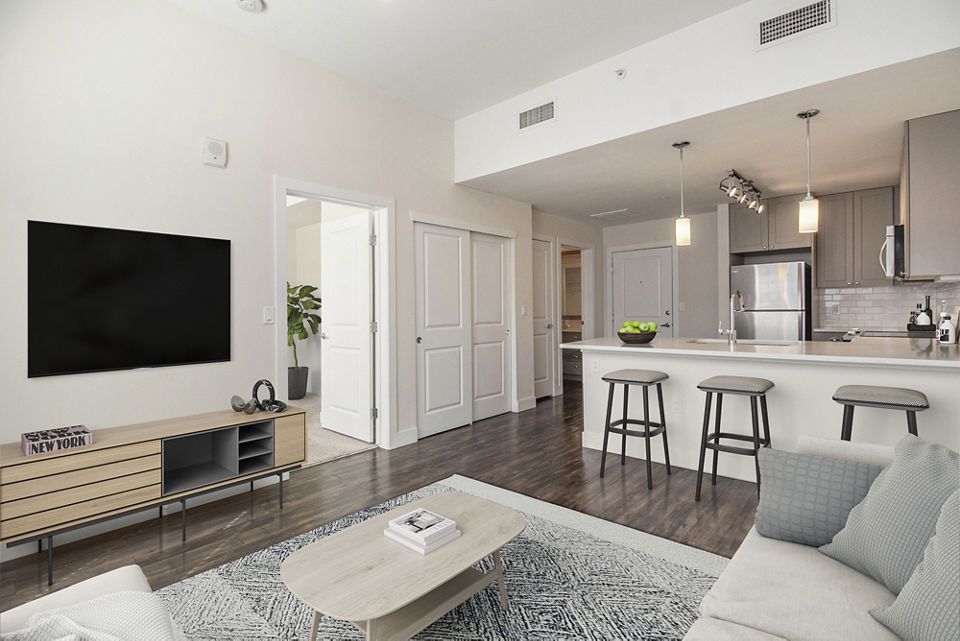 Cozy living room with modern decor and large windows at Highlands 32 Apartments, offering luxury living in the heart of the city