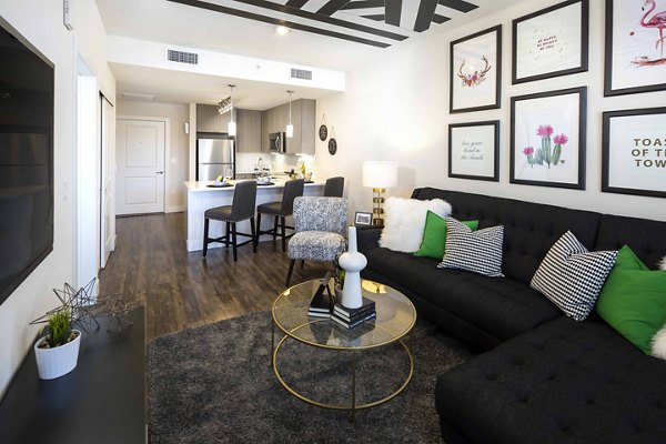 Modern living room with plush seating and large windows at Highlands 32 Apartments, offering a luxury living experience