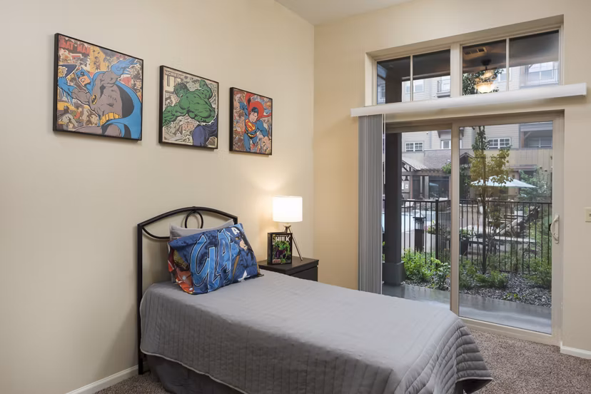 Comfortable bedroom with modern furnishings at Village at Aspen Place Apartments