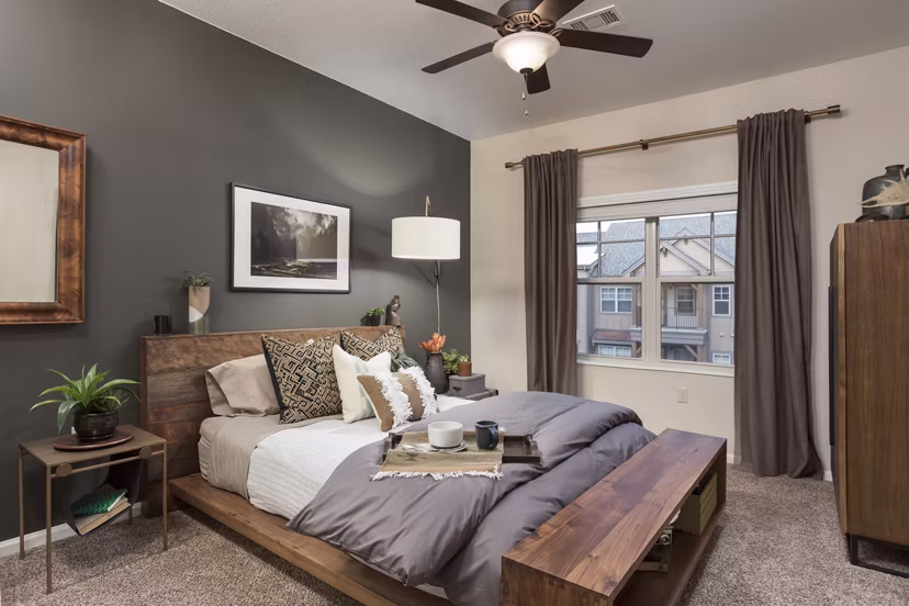 Bedroom with modern decor featuring plush bedding at Village at Aspen Place Apartments
