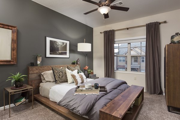 Bedroom with modern decor featuring plush bedding at Village at Aspen Place Apartments