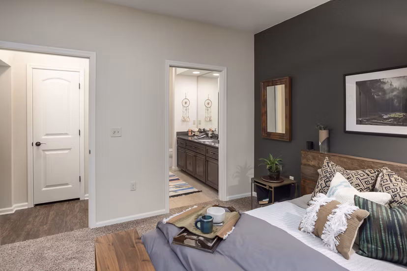 Cozy bedroom with modern furnishings at Village at Aspen Place Apartments in Flagstaff