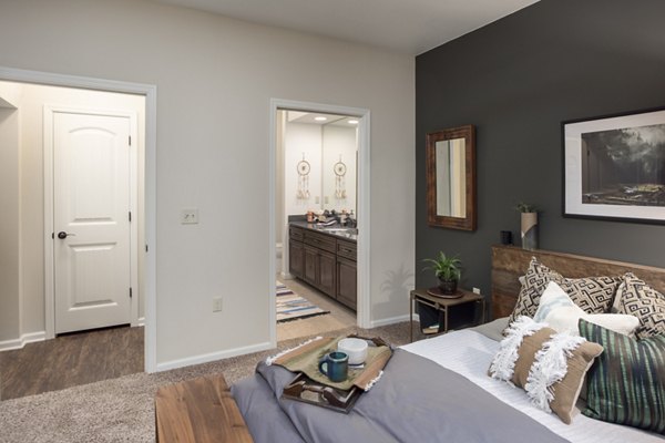 Cozy bedroom with modern furnishings at Village at Aspen Place Apartments in Flagstaff