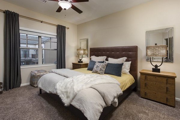 Spacious bedroom with modern decor at Village at Aspen Place Apartments, offering luxury living and comfort