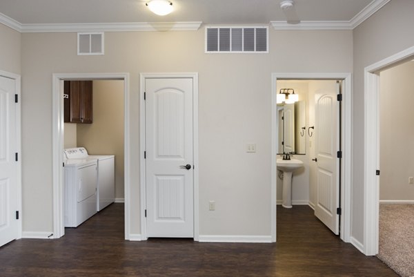 Hallway with modern lighting and elegant decor in Village at Aspen Place Apartments