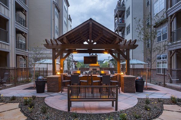 Grill area with seating at Village at Aspen Place luxury apartments