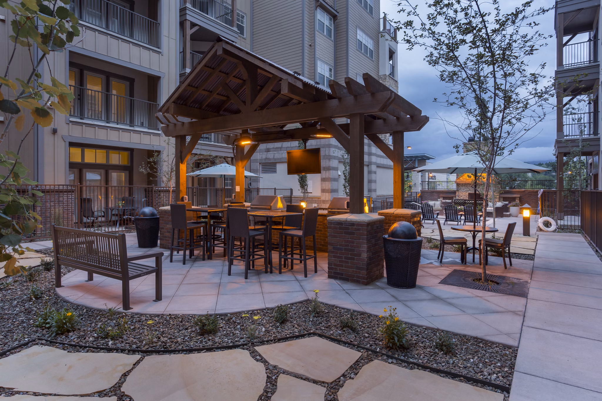 Outdoor grill area with seating at Village at Aspen Place Apartments, perfect for social gatherings and barbecues