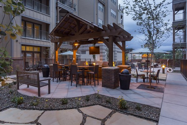 Outdoor grill area with seating at Village at Aspen Place Apartments, perfect for social gatherings and barbecues