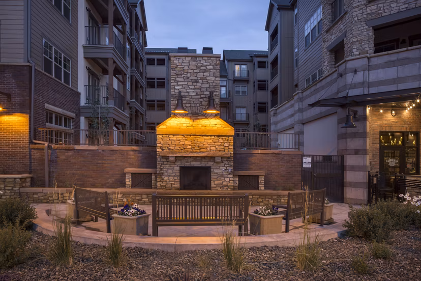 Fire pit with seating area at Village at Aspen Place Apartments, perfect for outdoor gatherings and relaxation