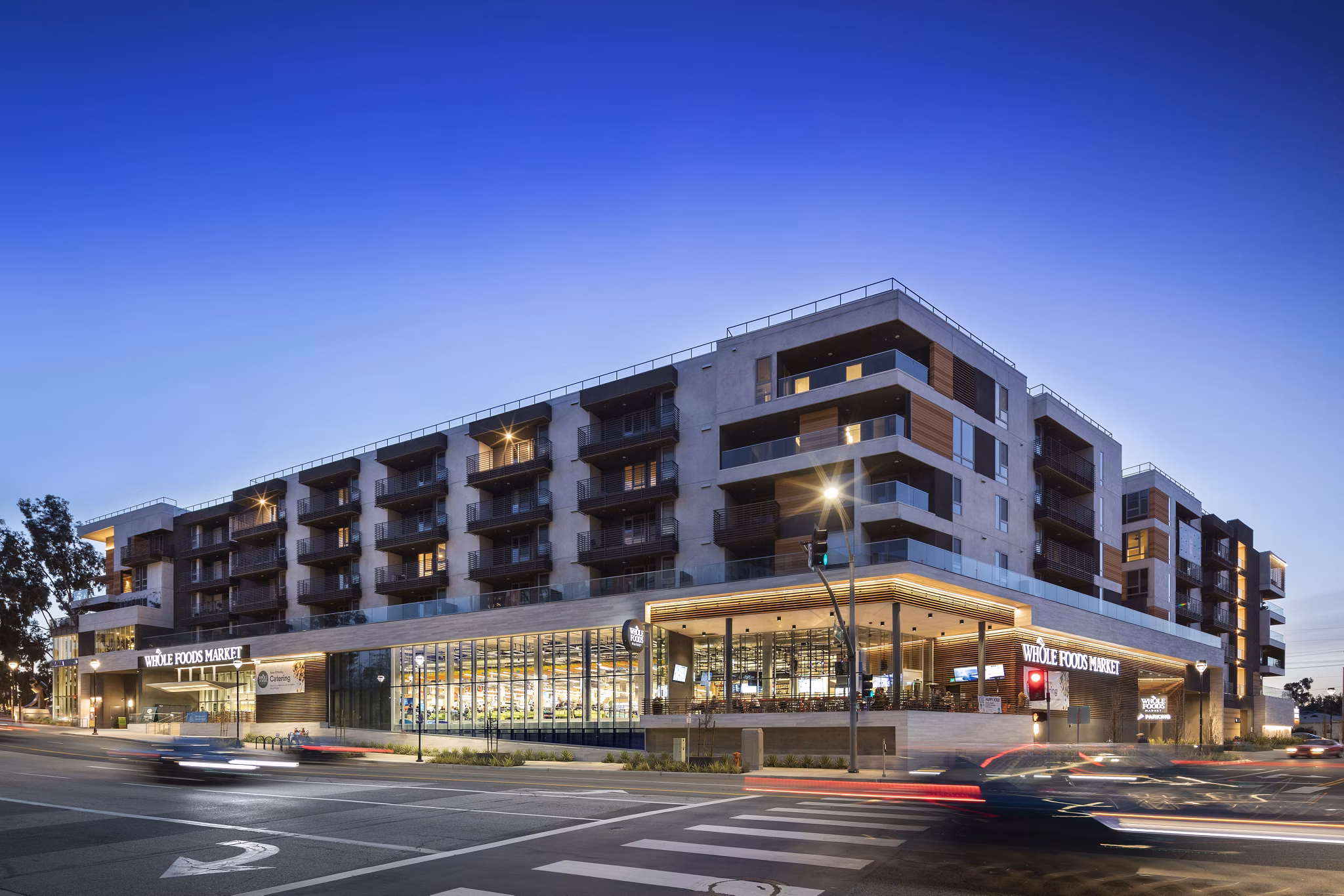 Talaria Apartments: Illuminated building for luxury living in Los Angeles Nighttime view highlights architectural elegance