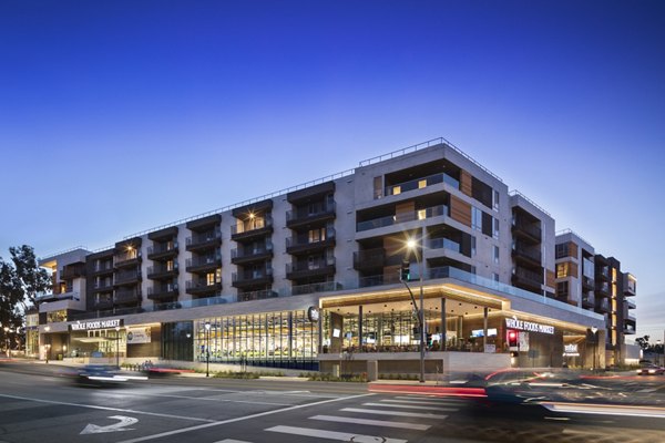 Talaria Apartments: Illuminated building for luxury living in Los Angeles Nighttime view highlights architectural elegance