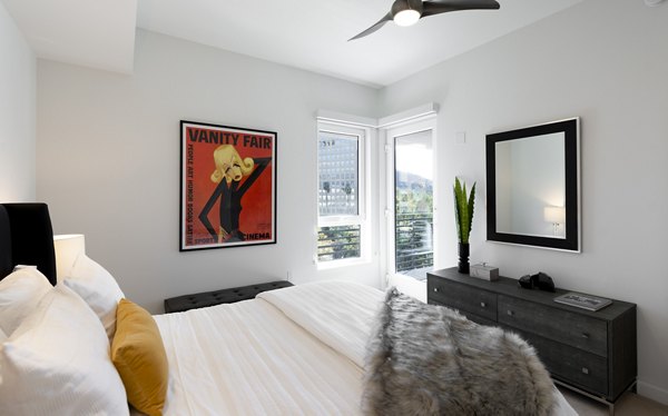 Cozy bedroom with modern furnishings at Talaria Apartments, showcasing luxury living at its finest