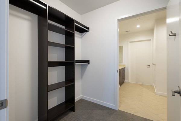 Walk-in closet with custom shelving at Talaria Apartments offering modern storage solutions