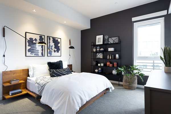 Bedroom featuring modern furnishings and natural light at Talaria Apartments
