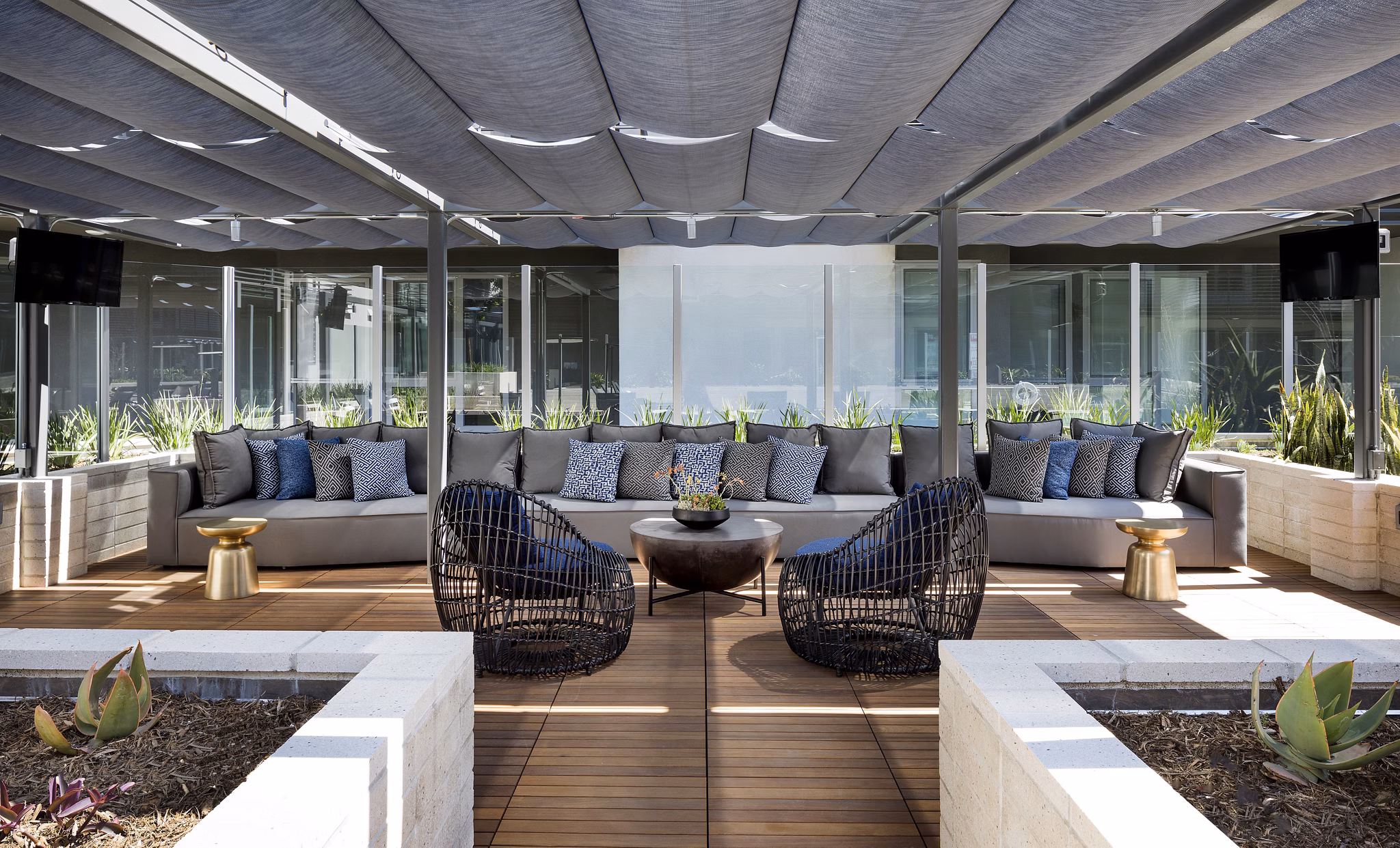 Talaria Apartments: Modern patio with seating area and greenery, perfect for relaxation and social gatherings