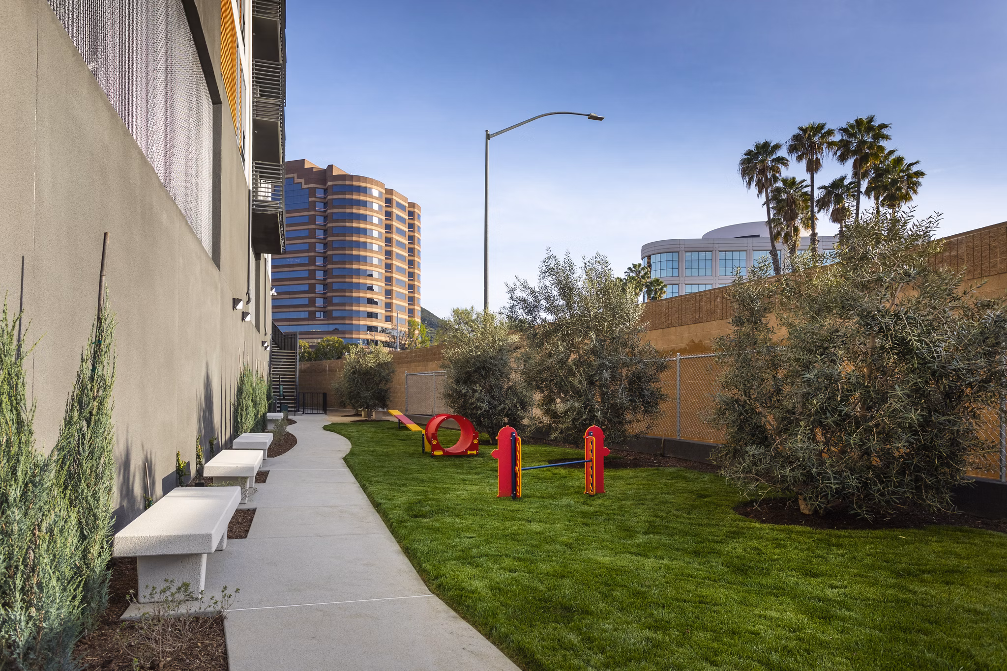 Outdoor dog run with agility equipment at Talaria Apartments, providing a pet-friendly amenity for residents to enjoy with their furry companions