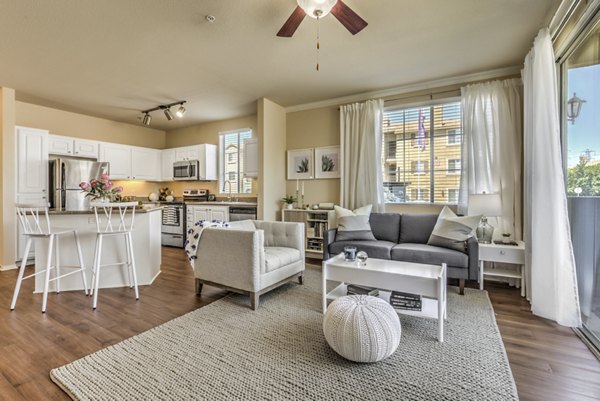 The Paseo at Town Center: Stylish living room with modern decor and abundant natural light in Greystar luxury apartments