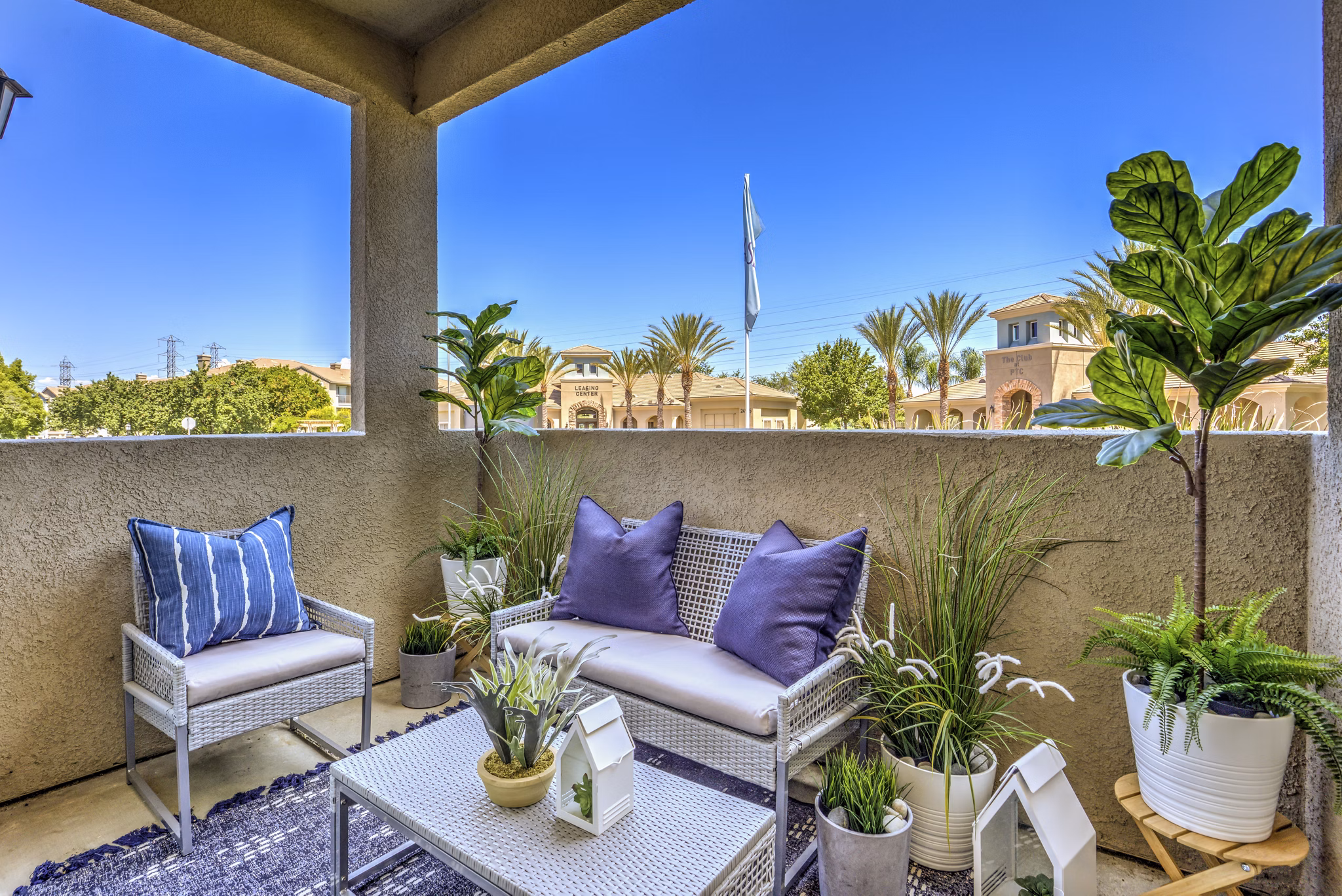 The Paseo at Town Center: Cozy patio with modern seating and lush greenery, ideal for relaxation and outdoor gatherings in a luxury setting