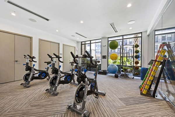 Fitness center at Broadstone River House Apartments equipped with state-of-the-art gym equipment for residents' health and wellness