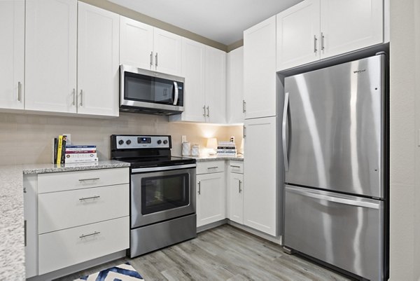 Modern kitchen with stainless steel appliances at Broadstone River House Apartments