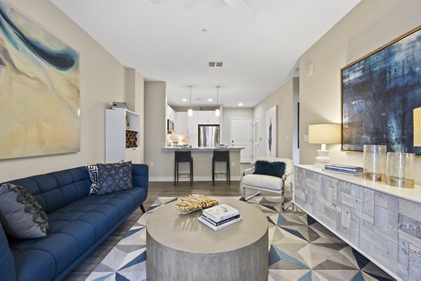 Contemporary living room with sleek furniture and large windows at Broadstone River House Apartments