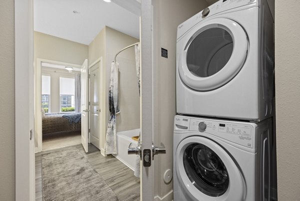 Laundry room with modern appliances at Broadstone River House Apartments