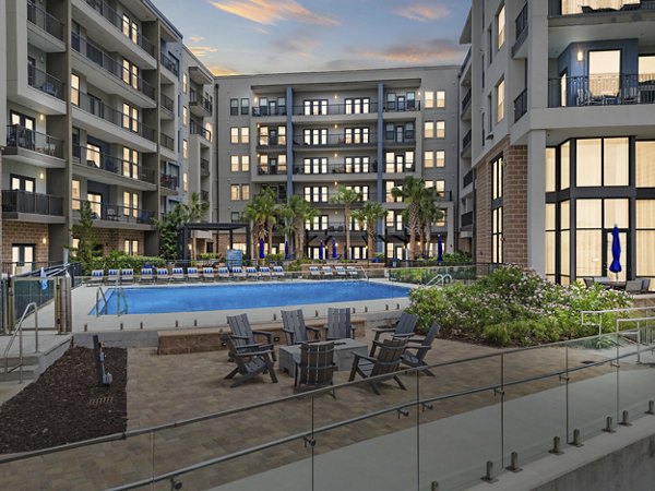 Riverside pool with modern lounge chairs at Broadstone River House Apartments