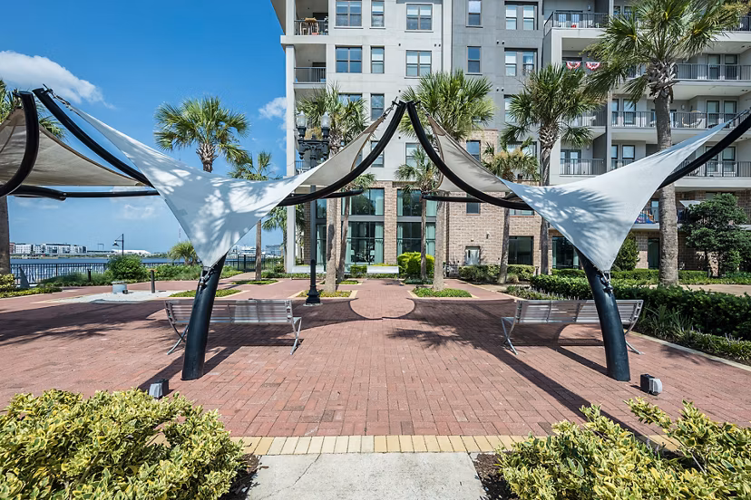 Cozy outdoor fire pit area at Broadstone River House Apartments, offering a relaxing social space with seating and ambient lighting
