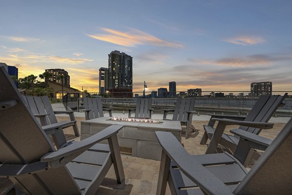 Cozy outdoor fire pit area at Broadstone River House Apartments, offering a relaxing social space with seating and ambient lighting