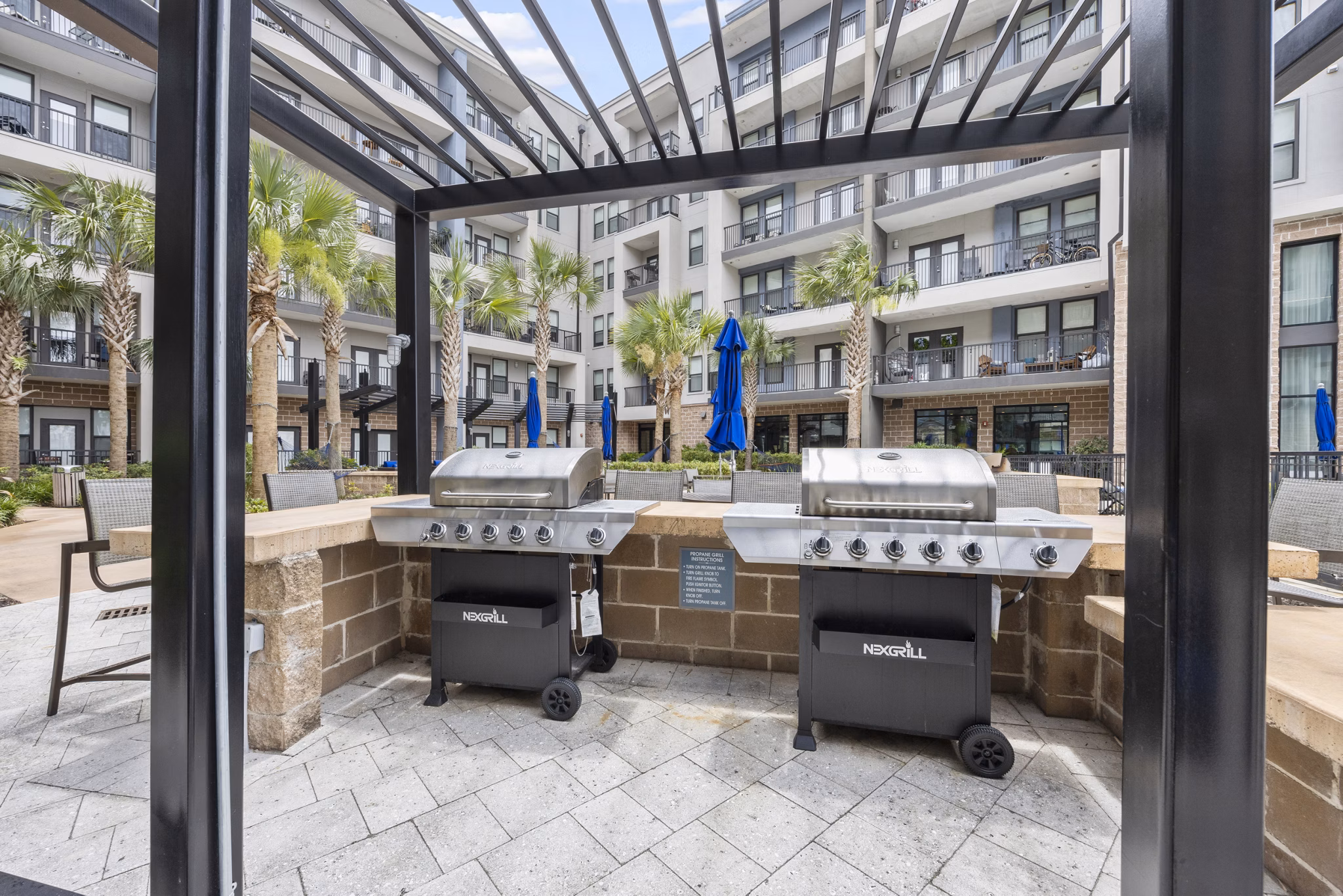 Grill area with modern outdoor seating at Broadstone River House Apartments