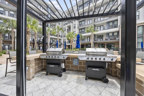 Grill area with modern outdoor seating at Broadstone River House Apartments