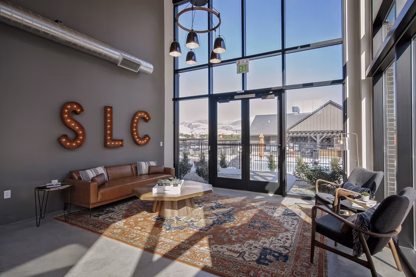 Contemporary clubhouse with modern seating and large windows at Meridian Apartments
