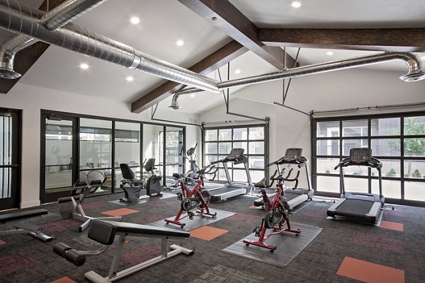 Meridian Apartments: Luxury fitness center with modern equipment and spacious workout area