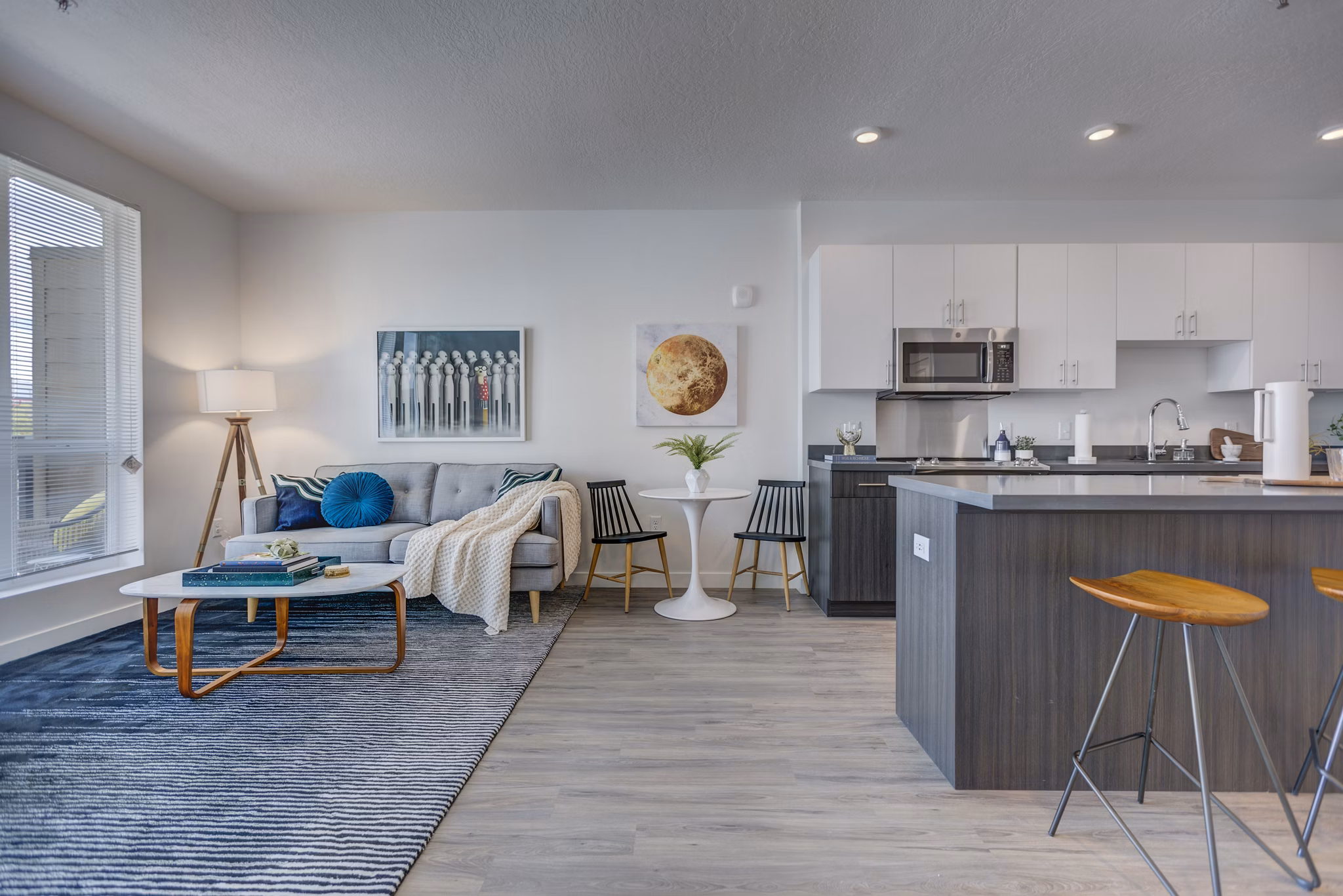 Spacious living room with modern decor and large windows in Meridian Apartments