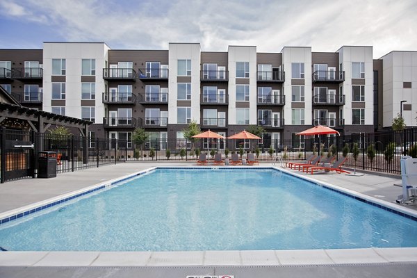 Luxurious pool area with palm trees at Meridian Apartments