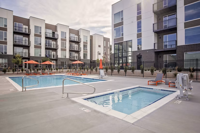 Sparkling pool surrounded by lush landscaping at Meridian Apartments