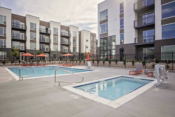 Sparkling pool surrounded by lush landscaping at Meridian Apartments