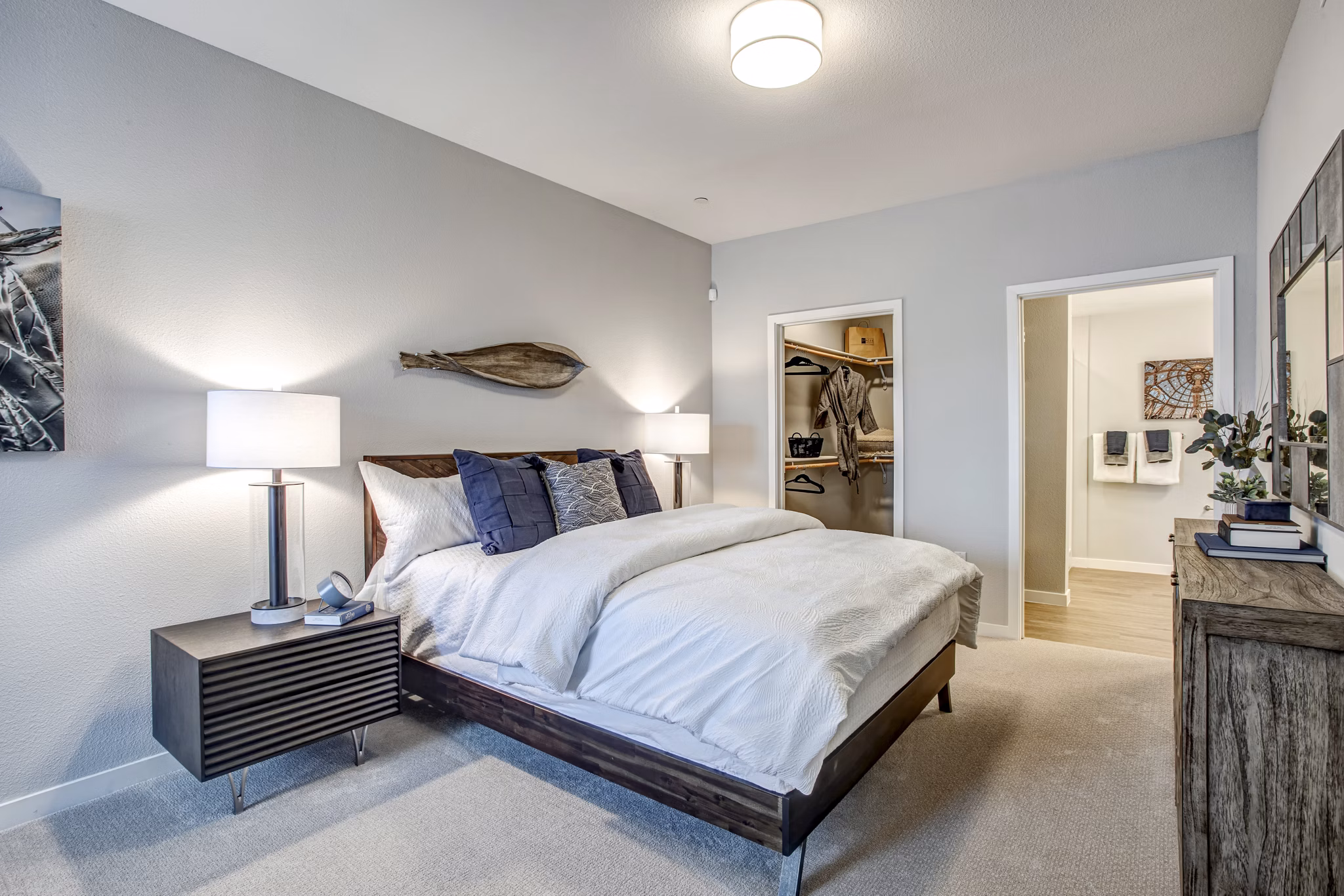 Cozy bedroom with modern decor at Inova Apartments featuring Greystar's luxury living experience