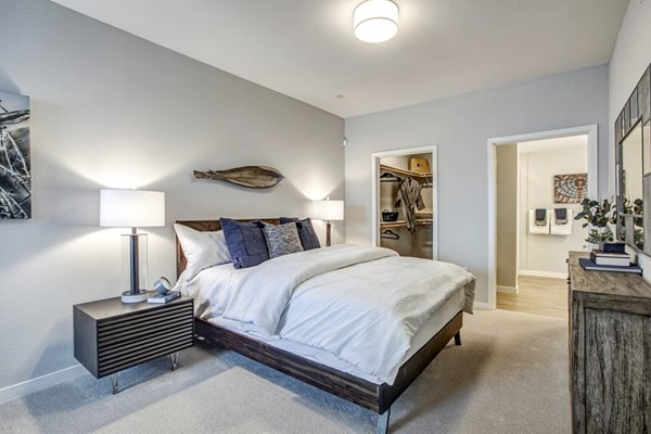 Cozy bedroom with modern decor at Inova Apartments featuring Greystar's luxury living experience