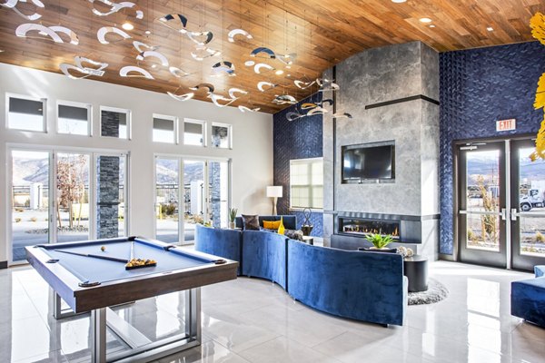 Clubhouse game room with billiards and seating in Inova Apartments, Greystar luxury community